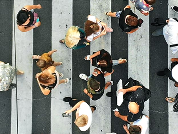 crowd of people walking on cross walk