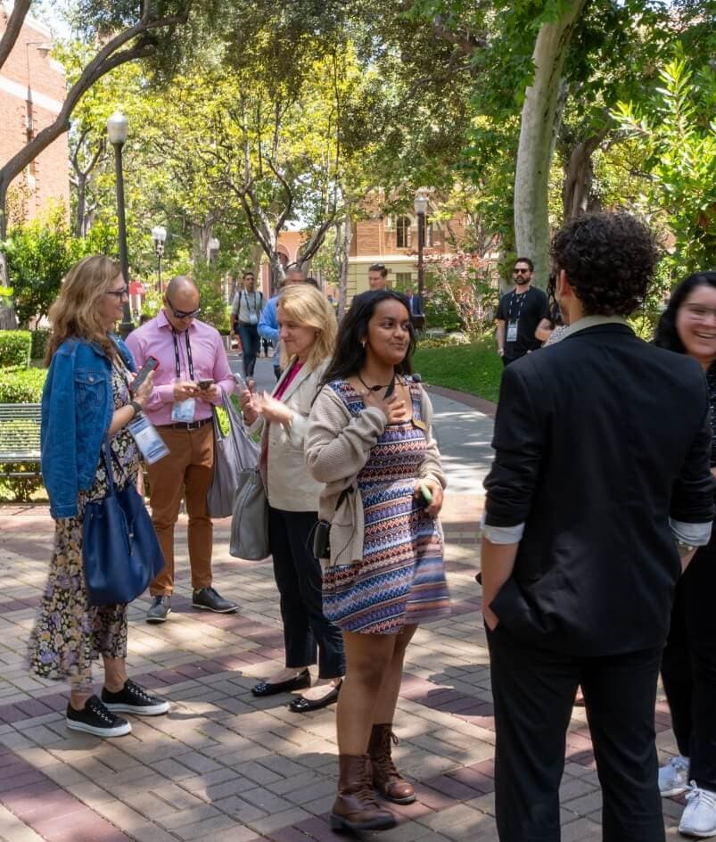 several people mingling in a park
